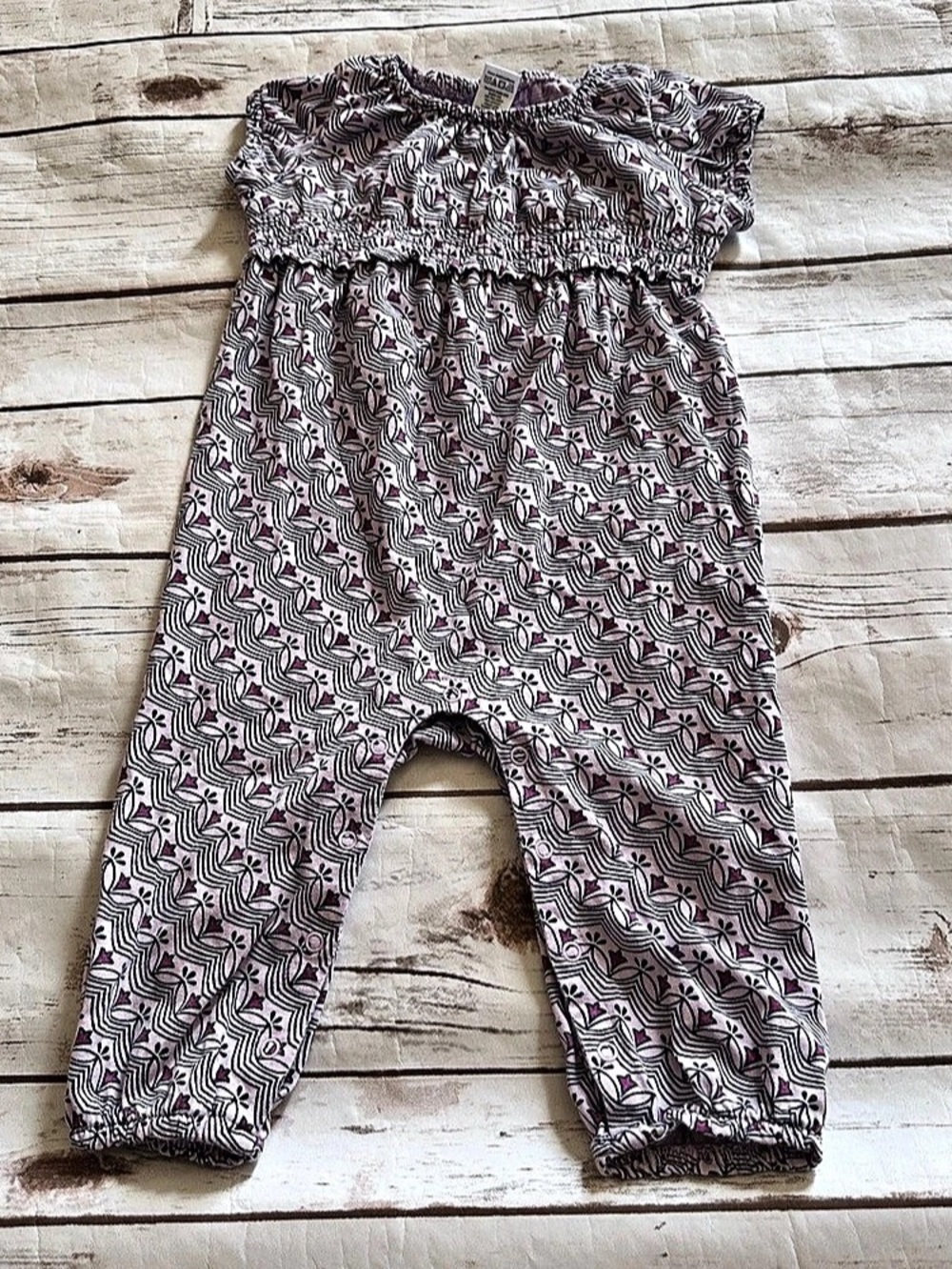 Tea collection romper with purple geometric pattern